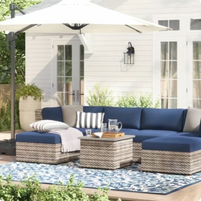 white exterior with white storm door and blue porch furniture