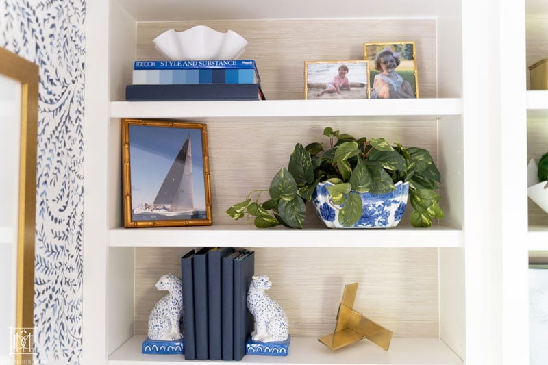 how to style built-in bookshelves with faux grasscloth