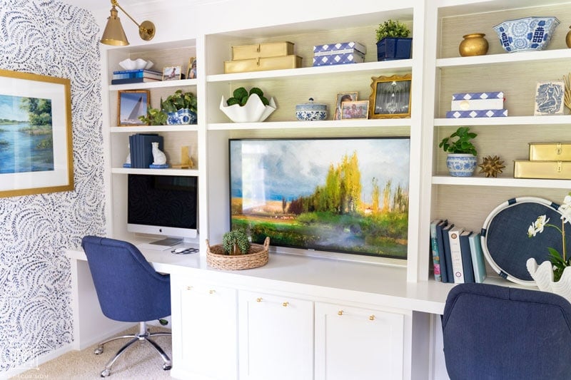 beautiful white built-in cabinets and desk with bookshelves in office and grasscloth wallpaper bookshelves