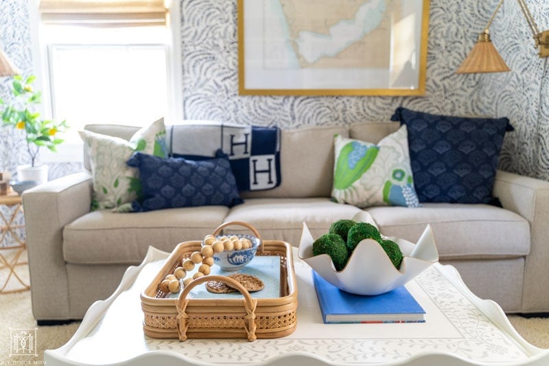 scalloped coffee table styled with bamboo and cane tray and wavy bowl