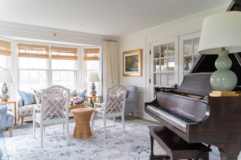 grandmillennial living room with white living room with grand piano- blue oriental rug