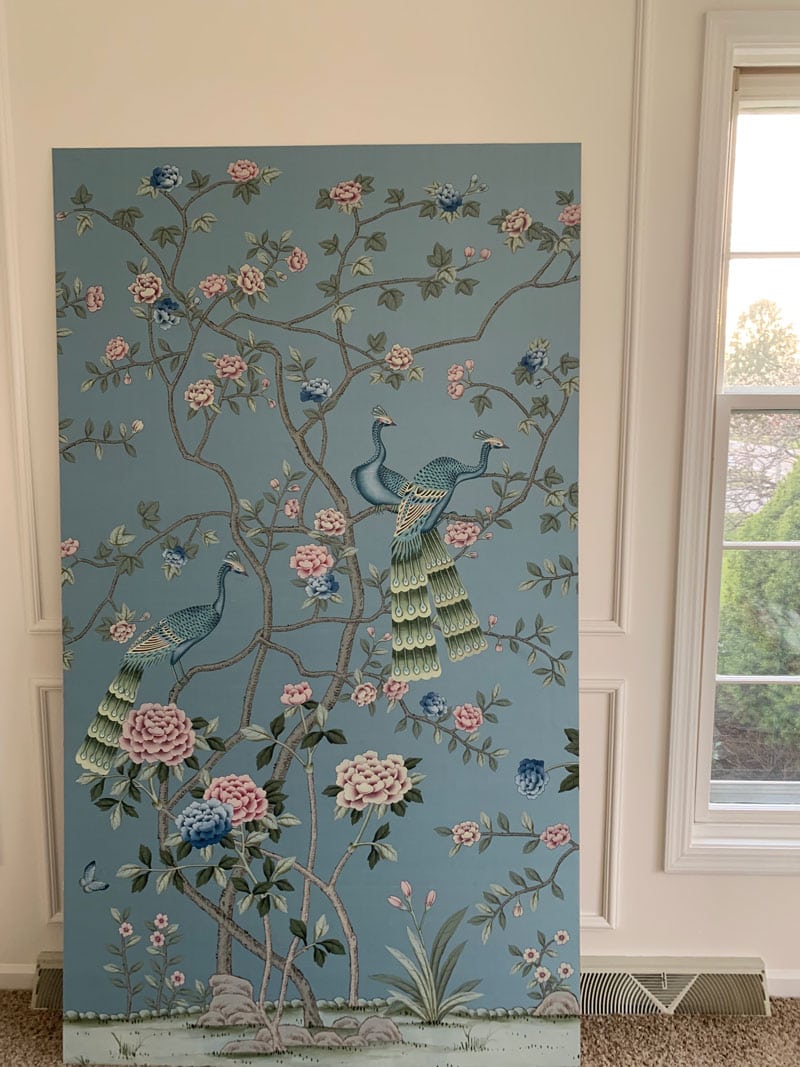 mounted but not hung chinoiserie panel leaning against wall in white wall living room